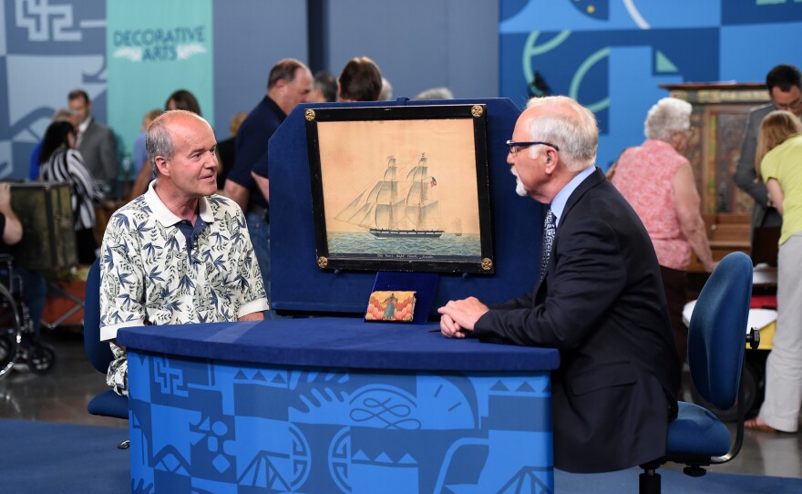 Stephen Fletcher (right) appraises a man’s flame stitch wallet and ship portrait, in Spokane, Wash. ANTIQUES ROADSHOW “Never Seen That Before!” airs Monday, May 12 at 8/7C PM on PBS.
