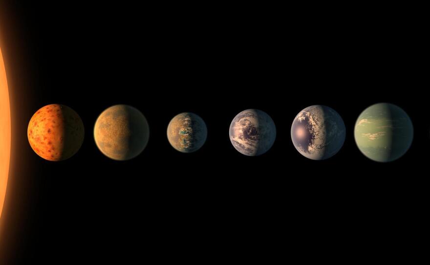 This artist's impression shows the TRAPPIST-1 star with its seven Earth-sized planets. The new telescope will be able to probe their atmospheres, if they have air.