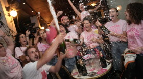 People spray sparkling wine as they celebrate early exit poll results for Israel's general election in Tel Aviv, Israel, Tuesday, Oct. 27, 2026.