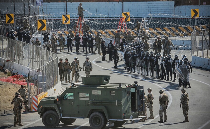 U.S. military and border agents secure the United States-Mexico border at the San Ysidro border crossing south of San Diego, Calif. on Nov. 25.