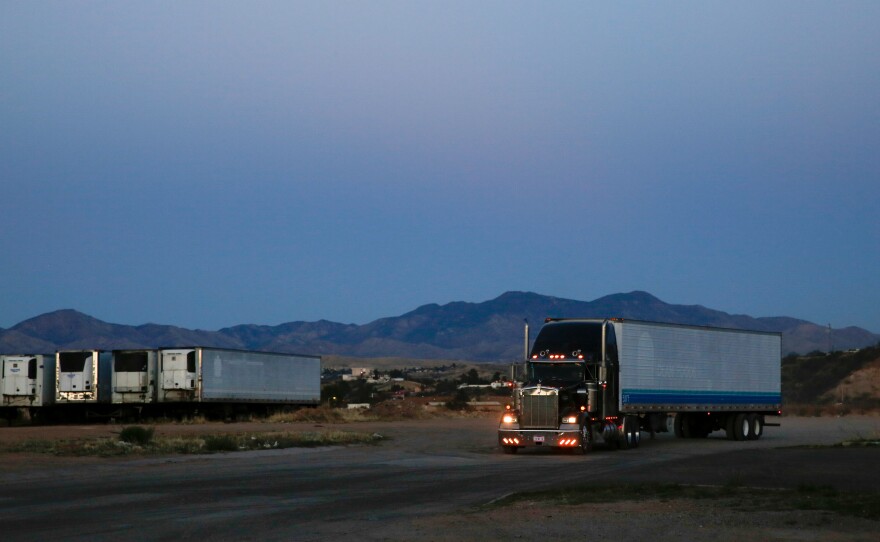 Trucks carrying produce head back across the U.S. border from Nogales.