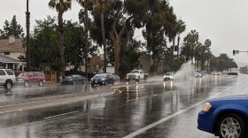 Cars drive in the rain at Mission Beach, Dec. 5, 2018. 
