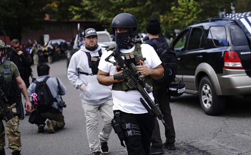 Armed participants walk at a Proud Boys rally with other right-wing demonstrators in September 2020 in Portland, Ore. Far-right groups celebrated the verdict in the Rittenhouse trial.