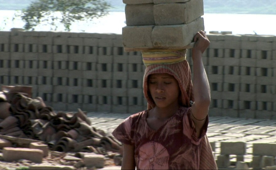 Kajal, eleven-year-old child laborer and budding activist, in the brickfield outside Calcutta where she lives and works.