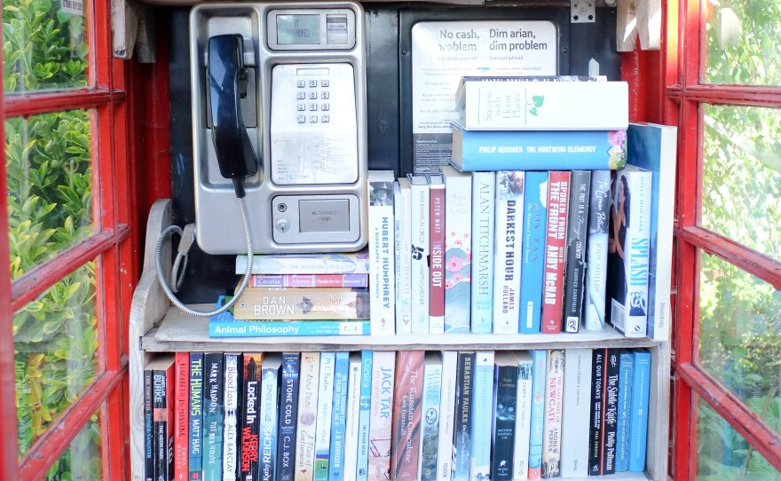 A red phone box in Michaelstone-le-Pit, Vale of Glamorgan, Wales, was converted into a village library. The U.K.'s regulator says more than 6,000 of the kiosks were converted into other uses, as cellphone use rose.