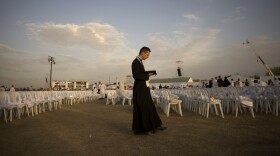 A priest prays before a Mass celebrated by Pope Benedict XVI at the Cuatro Vientos air base outside Madrid during World Youth Day festivities in August 2011. The Catholic Church is hoping to provide an attractive option for young job seekers in Spain, which is suffering from unprecedented unemployment.