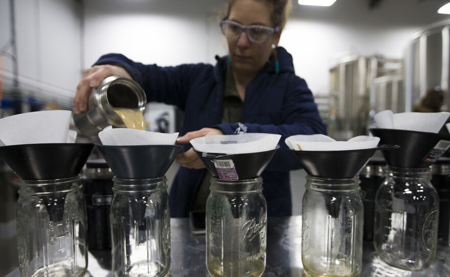 Andrea Stanley of Valley Malt in Hadley, Mass., steeps small amounts of malt as part of the international Pink Boots Collaboration Brew Day, an event meant to highlight women's growing influence on the beer industry.
