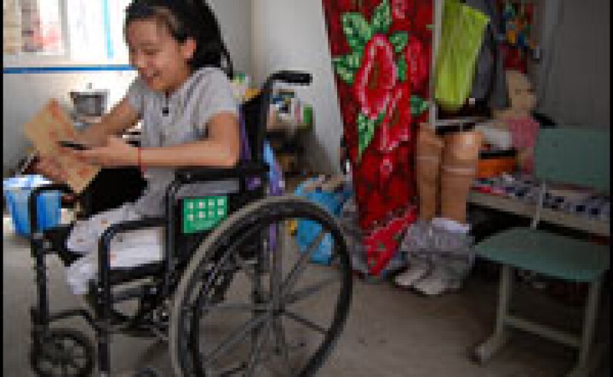 Huang Meihua, 12, had both legs amputated above the knee after her school collapsed on her on May 12, 2008. The government provided her with free prosthetic legs, but she says they're heavy and uncomfortable.