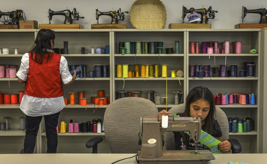 Brightly colored skeins and rolls of rick rack sit beneath vintage Singer sewing machines still in use by Seminole tribal elders in the Art and Culture Center on July, 24, 2015 in Hollywood, Fla.