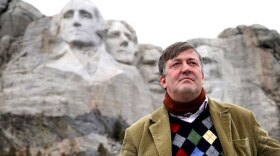 Stephen Fry stands in front of Mt. Rushmore on his journey to explore the United States. 