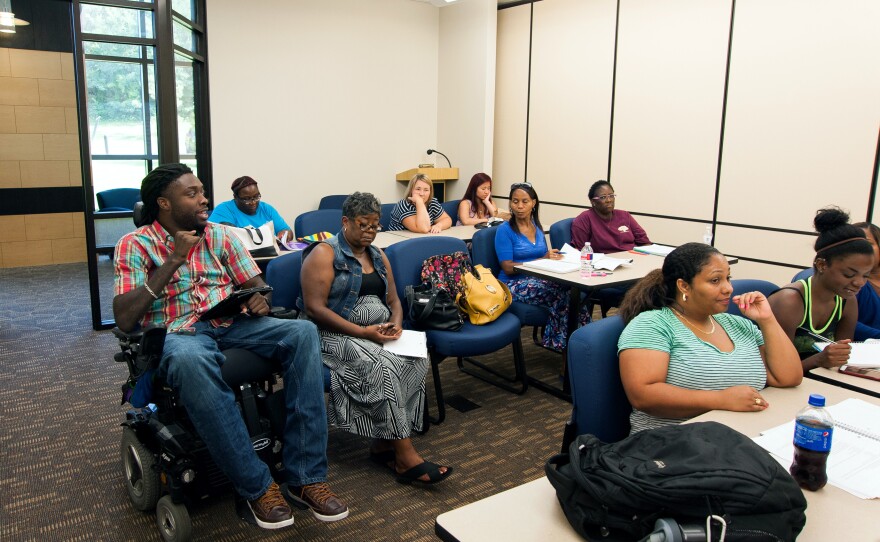 Nnaka has a discussion with fellow students during a class at Langston University's Tulsa campus.