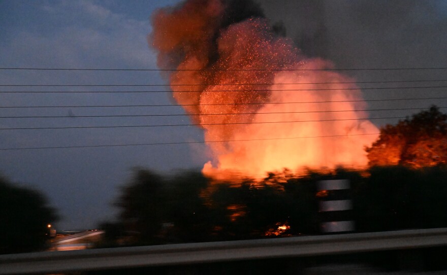 Fire burns after an apparent rocket attack on an open field, following a convoy that was entering its last run to rescue a family from Sderot.