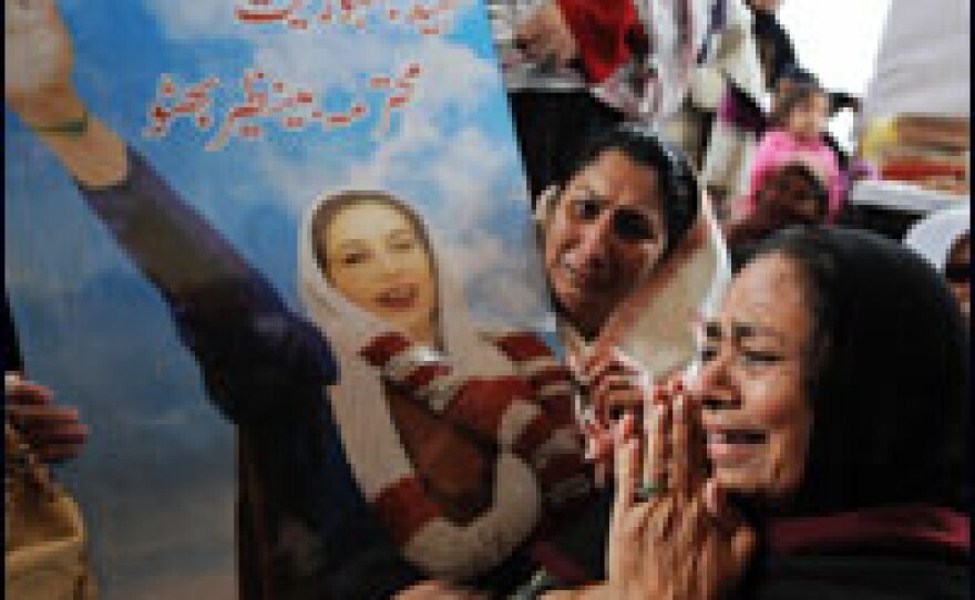 Mourners express their grief Thursday as they hold a poster of slain opposition leader Benazir Bhutto during a ceremony in Rawalpindi, Pakistan.