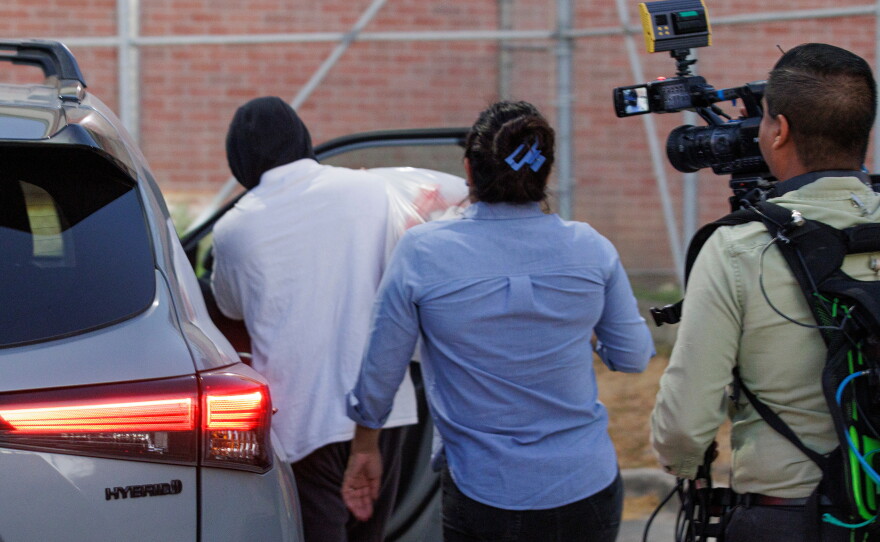 Immigration and Customs Enforcement officer Christian Castro gets into a car surrounded by news reporters moments after being released from the Carrizalez-Rucker Cameron County Detention Center in Brownsville, Texas on Aug. 27, 2026.