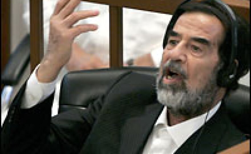 Former Iraqi President Saddam Hussein at trial on Tuesday in Baghdad.