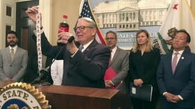 California state Sen. Bob Monning, D-Carmel, illustrates the amount of sugary in a typical soft drink while discussing a package of five bills aimed at discouraging consumption of sugary beverages, at the California state Capitol in Sacramento on Wednesday, Feb. 20, 2019.