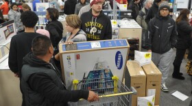 Shoppers line up in a Best Buy store in Rockville, Md., during a Black Friday sale. Thanksgiving weekend sales jumped nearly 13 percent from last year, the National Retail Federation says.