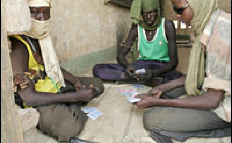 Rebels from the Sudanese Liberation Army play cards in a house in a deserted village in northern Darfur, May 2006. This branch of the SLA refused to sign the peace deal concluded in May between Sudan's government and another SLA faction, led by Minni Minnawi.