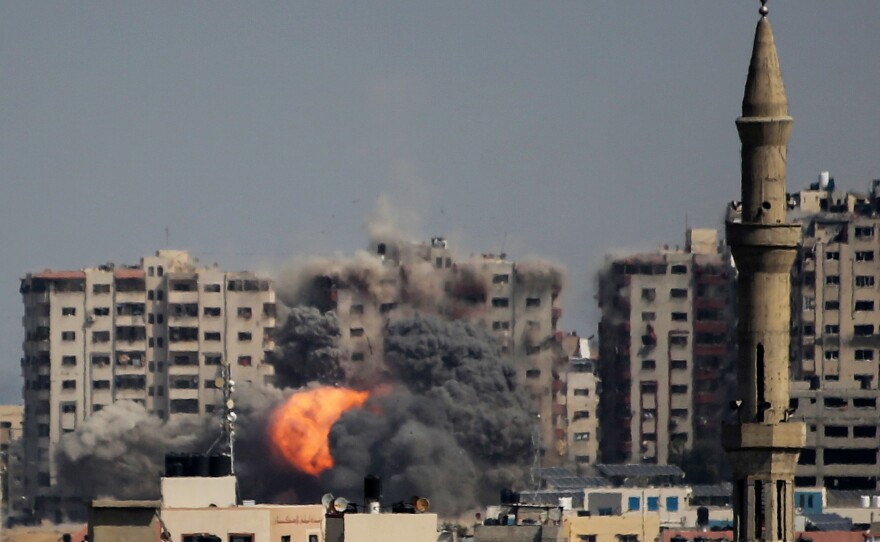 Israeli forces strike a residential tower in Gaza City on Thursday.