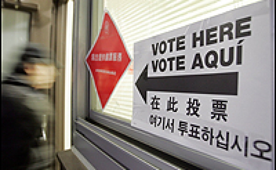 A voter is greeted by instructions written in English, Spanish, Chinese and Korean at the entrance to a polling place in New York City's Chinatown.