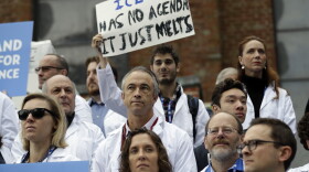 Scientists hold signs during a rally in conjunction with the American Geophysical Union's fall meeting in San Francisco, Dec. 13, 2016.