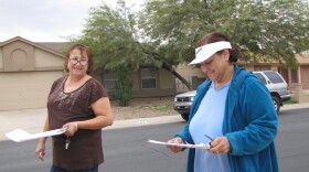 Democratic organizers Rebecca Larios (left) and Norma Muñoz canvass a South Phoenix neighborhood ahead of President Obama's visit.