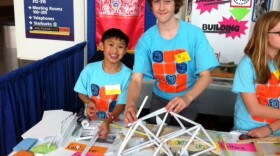 Caleb Leung (left) and Scully Randlett, 7th graders at Alice Fong Yu K-8 Chinese Immersion School in San Francisco, build a cantilever bridge Monday using paper rolls and scotch tape at the STEM Symposium in Sacramento. 