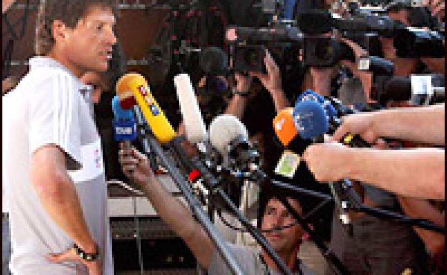 Germany's Jan Ullrich talks to the media in front of his hotel in Blaesheim near Strasbourg on Friday. A favorite to win, Ullrich has withdrawn from the Tour de France under the cloud of a doping scandal in Spain.