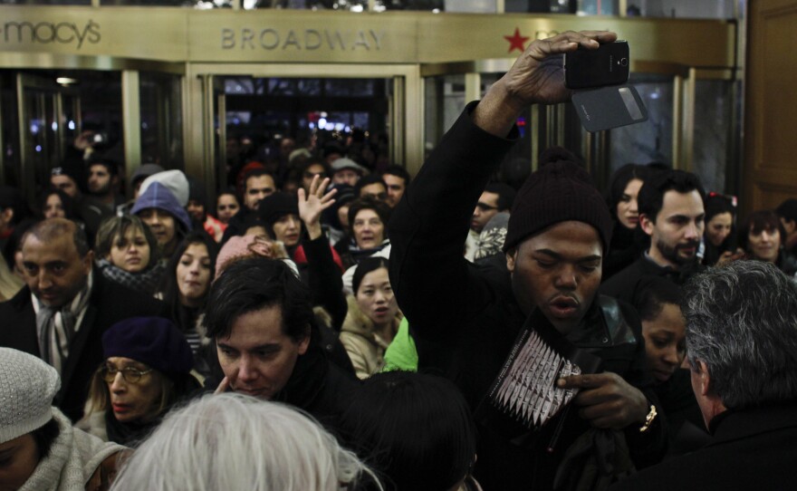 People enter Macy's Herald Square store after opening its doors at 8 p.m. on Thanksgiving Day in New York City.