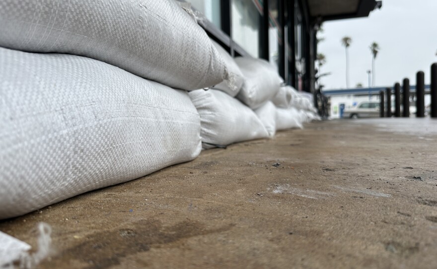 A business in Ocean Beach prepared for Tropical Storm Hilary by lining up sand bags, Aug. 20, 2023.