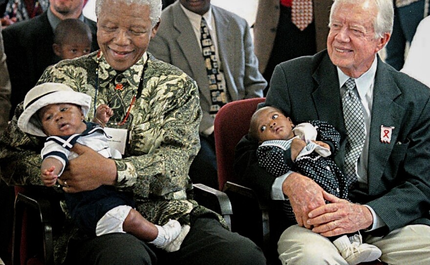 Former President Jimmy Carter has worked to end neglected diseases since 1982. Here he sits with former South African President Nelson Mandela at a ceremony in Soweto in 2002, marking a new AIDS project.