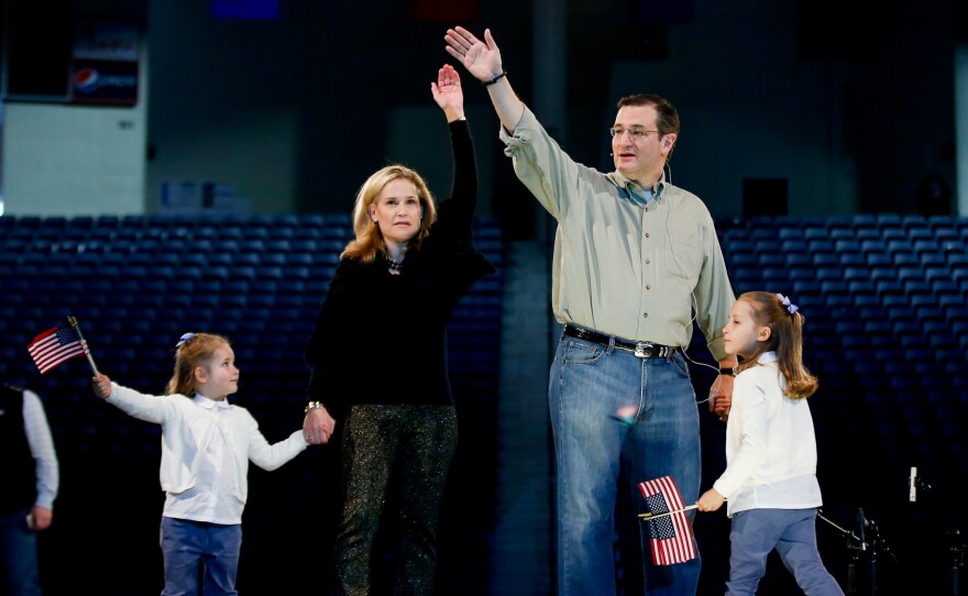 Sen. Ted Cruz, wife Heidi, and two daughters Catherine, 4, left, and Caroline, 6, practice waving on stage at Liberty University before Cruz's Monday launch presidential campaign launch.