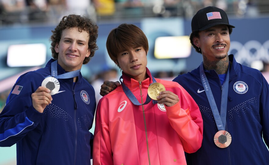 Gold medalist Yuto Horigome, of Japan, center, poses with silver medalist Jagger Eaton, of the United States, left, and bronze medalist Nyjah Huston, of the United States, after the men's skateboard street final at the 2024 Summer Olympics, Monday, July 29, 2024, in Paris, France.