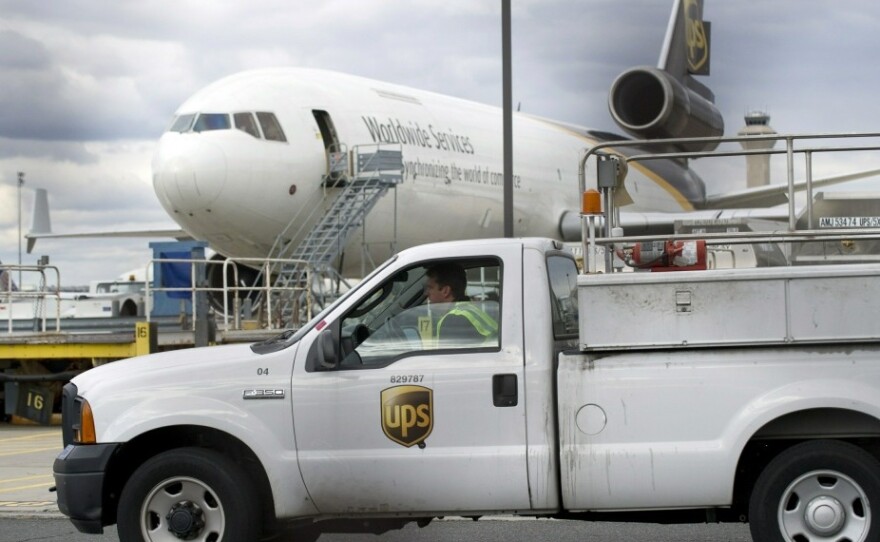 A UPS worker drives past a UPS plane at Liberty Airport in Newark, N.J., on Friday. Two suspicious packages intercepted on cargo planes in transit to the United States were addressed to Jewish synagogues in Chicago, the FBI said.