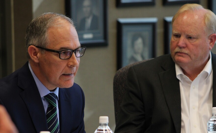 Steve Nelson (right), president of the Nebraska Farm Bureau, looks on as Scott Pruitt talks to farmers in Reliance, S.D.