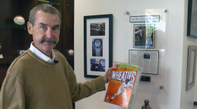 Peter Seidler holds a Wheaties box featuring Tony Gwynn.