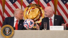 President Trump and FIFA President Gianni Infantino talk during a FIFA task force meeting in the East Room of the White House, May 6, 2025, in Washington.