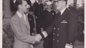 Maurice Young, 26, is congratulated by Rear Adm. R. S. Holmes upon being the 3,000th man to enlist in the Navy in San Diego after the attack on Pearl Harbor.