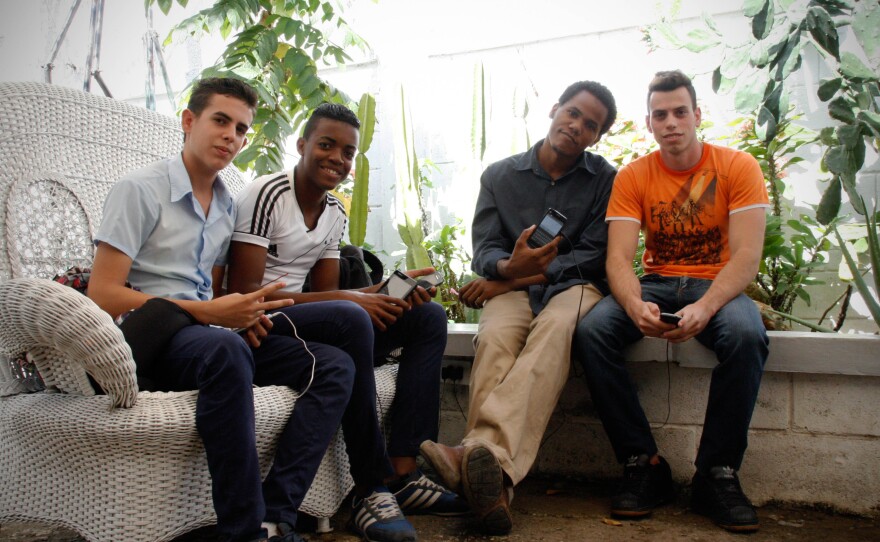 Yoan Istameyer, 29, in the black shirt, and Yendy Rodriguez, 20, wearing orange, spend hours at KCho's studio connected to the Internet. Istameyer says that when his girlfriend asked him to choose between her and his Wi-Fi connection, he chose the Internet.