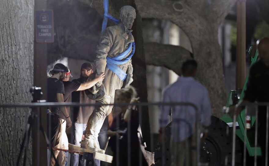 A statue of Confederate Gen. Robert E. Lee is removed from the University of Texas campus, early Monday morning in Austin.