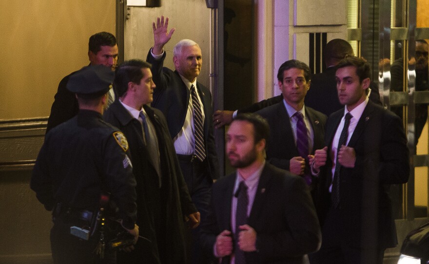 Vice President-elect Mike Pence, top center, leaves the Richard Rodgers Theatre after a performance of "Hamilton" on Friday.