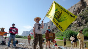 John Rakowitz waves a 'Don't tread on Big Bend' flag at a rally at Big Bend National Park, a pristine pocket of the West Texas border where the federal government is looking to build patrol roads, vehicle barriers and surveillance systems.