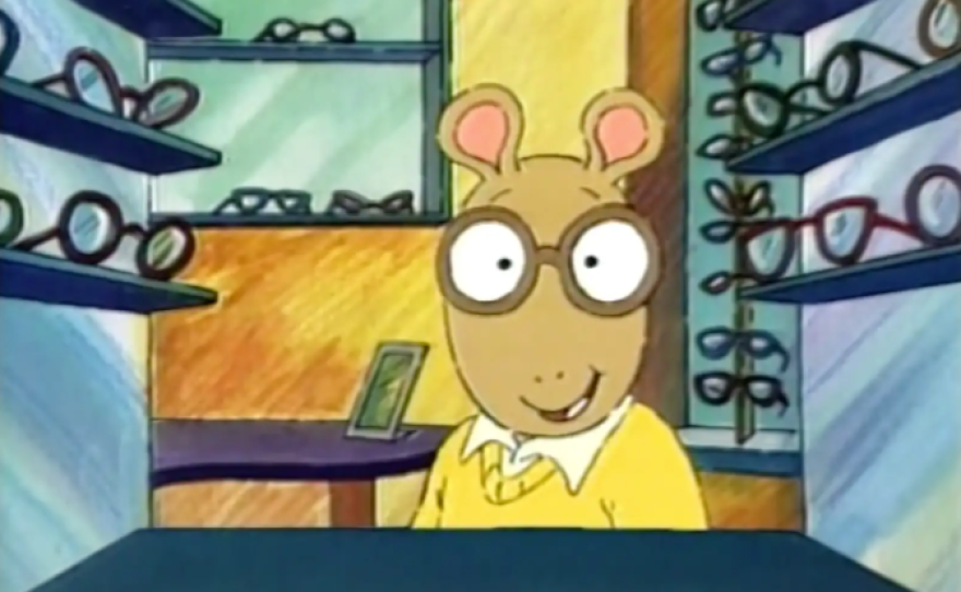 In the first episode of Arthur, the titular character (center) tries on a pair of brown glasses.