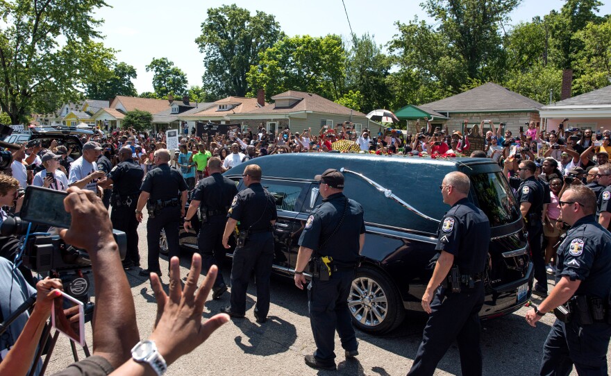 The hearse carrying Muhammad Ali drives along in the funeral procession motorcade on Grand Avenue in the front of Ali's childhood home in Louisville, Ky. The funeral procession for Ali was traveling over 20 miles on a designated route throughout Louisville on the way to Cave Hill Cemetery. The four-time world heavyweight boxing champion died on June 3 at age 74.