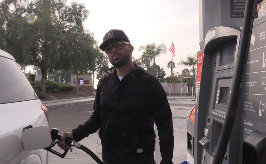 Jovanim Martinez fueling up his car in Chula Vista, Nov. 18, 2021.