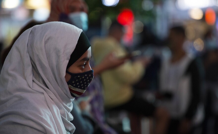 A woman wears a hijab and an American flag mask during an Election Day celebration at Times Square on Saturday, Nov. 2020 in New York, NY. Joe Biden received a record-breaking 75 million votes during the 2020 Presidential Election against Donald Trump.
