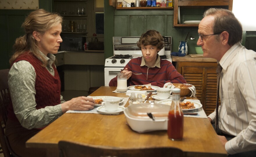 The story of Olive and her family is told mostly in a series of flashbacks. Above, Olive (McDormand), her husband, Henry (Richard Jenkins), and their son, Christopher (Devin McKenzie), have a tense moment at the dinner table.