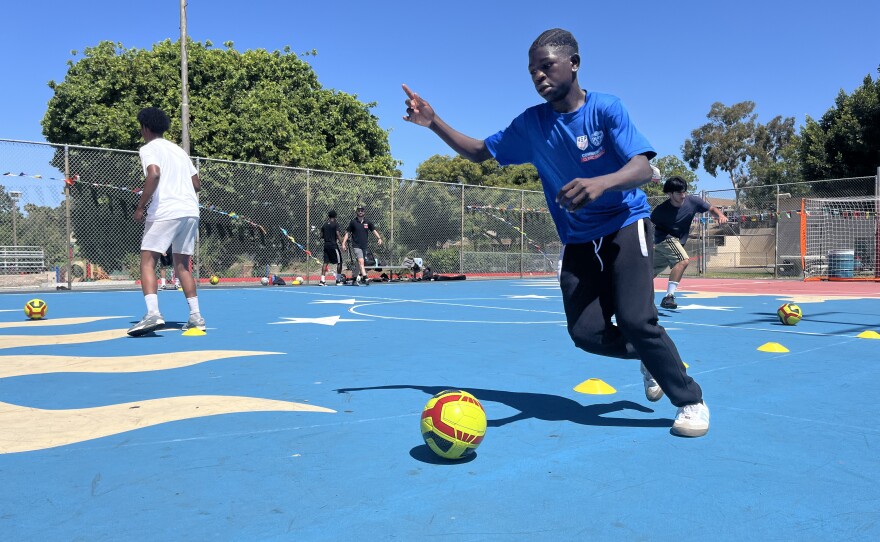 A young boy dribbles a soccer ball on the basketball courts at Colina Del Sol Park, July 10, 2025.
