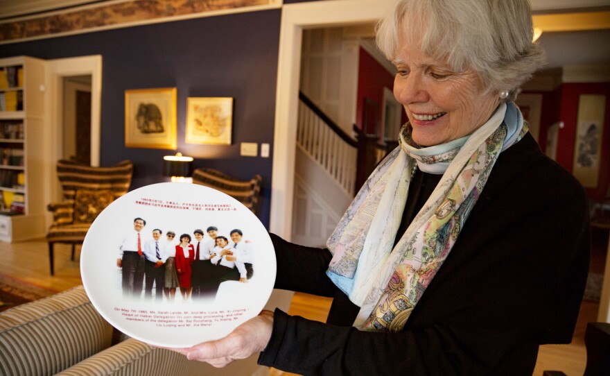 Sarah Lande shows off a plate commemorating Xi Jinping's 1985 trip to Muscatine, Iowa. Lande helped organize Xi's visit that year.