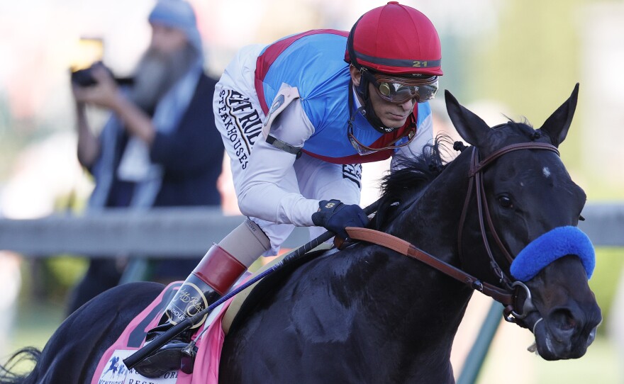 Medina Spirit, ridden by jockey John Velazquez, leads the field  during the Kentucky Derby in Louisville on May 1. On Sunday, trainer Bob Baffert revealed the Derby winner had failed a drug test.